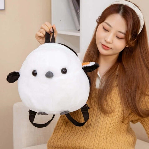 young woman looking at white fluffy cute kawaii chonky sparrow bird plushie backpack bag with wings