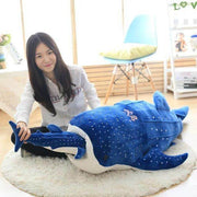 young woman playing with big and small huge XXL dark blue whale shark plushie pillows with open mouth