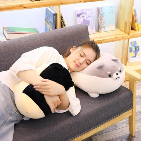 young woman cuddling with black and gray cute kawaii chonky angry shiba inu plushies