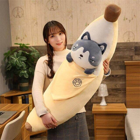 young woman holding cute kawaii chonky banana husky dog plushie