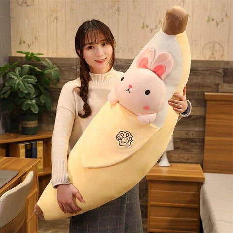 young woman holding cute kawaii chonky banana bunny rabbit plushie