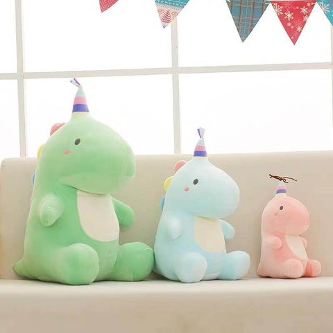 pink, green, and blue cute kawaii chonky dinosaur plushies with birthday party hats