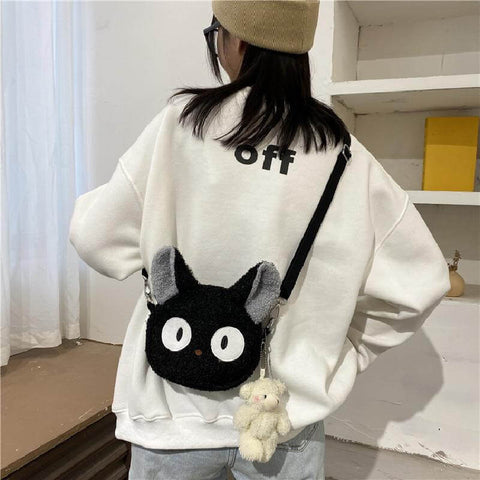 young woman wearing cute kawaii chonky fluffy animal head handbag and bag with shoulder straps in black cat design