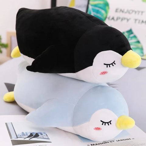 blue and black sleepy cute kawaii chonky penguin plushies lying down