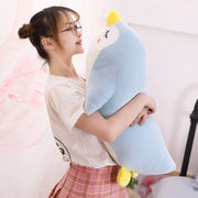 young woman hugging blue sleepy cute kawaii chonky penguin plushie