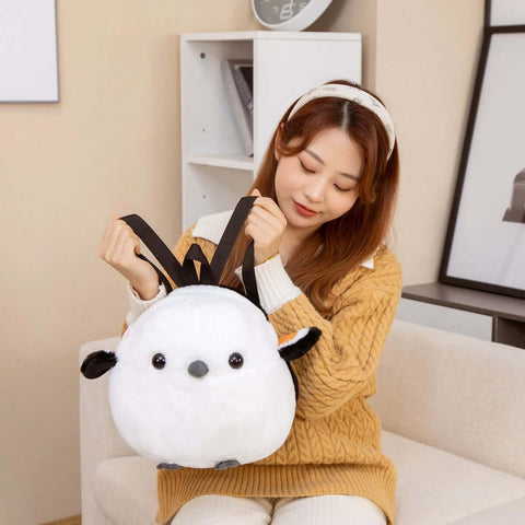 young woman wearing white fluffy cute kawaii chonky sparrow bird plushie backpack bag with wings