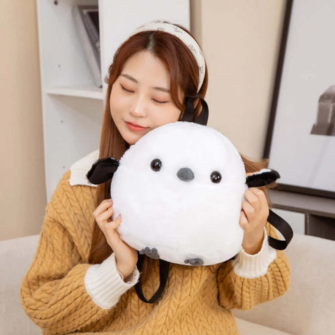 young woman cuddling with white fluffy cute kawaii chonky sparrow bird plushie backpack bag with wings