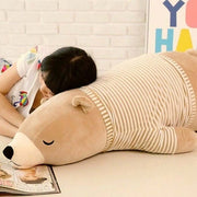 young woman sleeping on brown sleepy cute kawaii chonky bear plushie in sweater pullover lying down