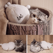 Adorable pet cat playing with cute kawaii chonky gray seal plushie