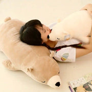 young woman sleeping on brown sleepy cute kawaii chonky bear plushie lying down