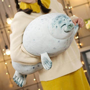 young woman holding cute kawaii chonky seal plushie pillow with realistic print design