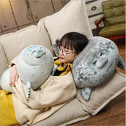 young woman cuddling with cute kawaii chonky seal plushie pillows with realistic print design