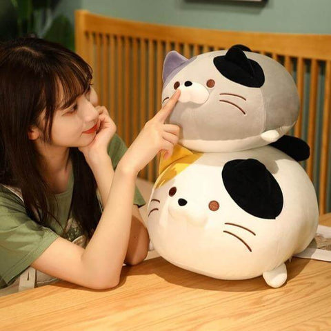 young woman playing with cute kawaii chonky squishy soft kitty cat plushies
