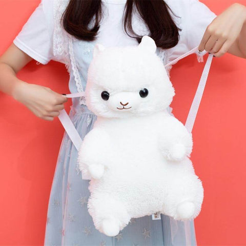 young woman holding cute kawaii chonky white color alpaca llama backpack