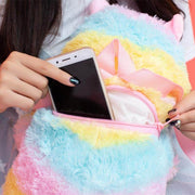 young woman putting smartphone into cute kawaii chonky rainbow color alpaca llama backpack