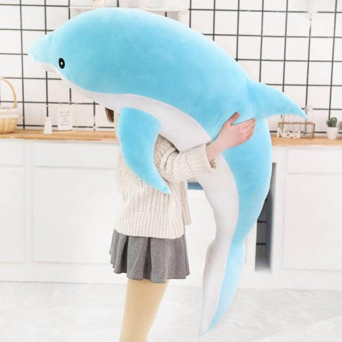 young woman hugging big huge XXL baby blue dolphin plushie pillow
