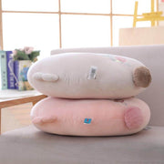 pink and white gray cute kawaii chonky soft round bunny rabbit plushie pilow with fluffy floppy ears lying on sofa couch bed