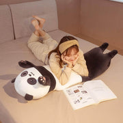 Young woman lying in bed with long cute kawaii chonky panda bear dakimakura plushie body pillow