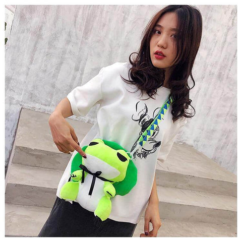 young woman wearing cute kawaii chonky green frog bag with green hat