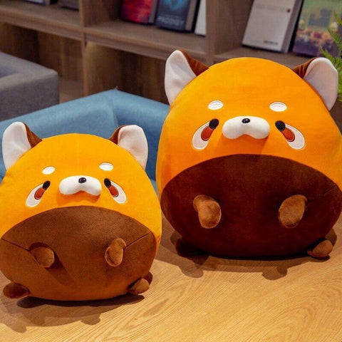 big and small cute chonky orange racoon plushies in a living room