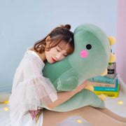young woman cuddling with a cute kawaii chonky squishy big green dinosaur plushie