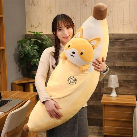 young woman holding cute kawaii chonky banana shiba inu dog plushie