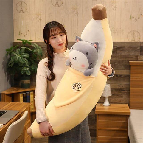 young woman holding cute kawaii chonky banana cat plushie