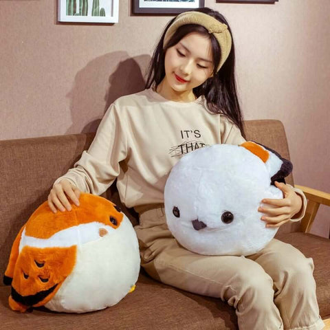 young woman cuddling cute kawaii chonky round borb birb bird plushie with brown, white, and black wings