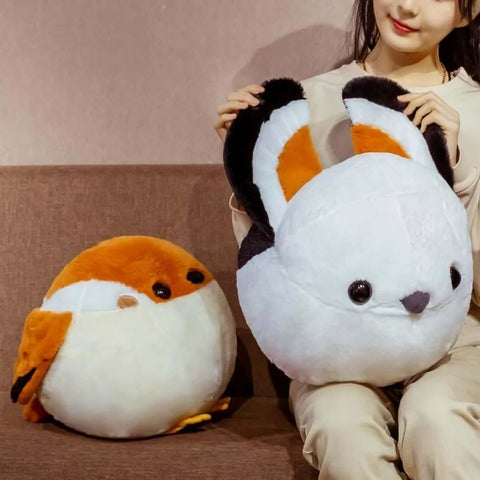 young woman playing with cute kawaii chonky round borb birb bird plushie with brown, white, and black wings