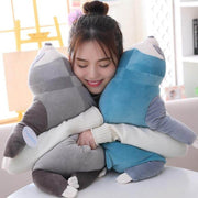 young woman cuddling with sleepy cute kawaii chonky sloth plushies lying down