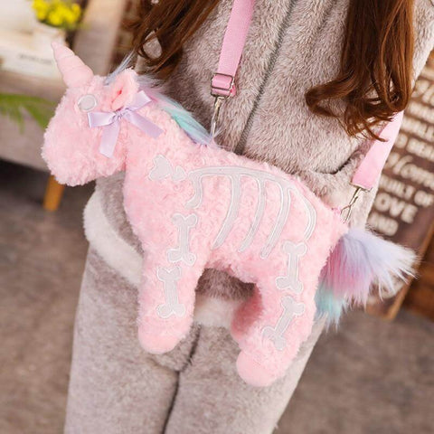 young woman wearing cute kawaii chonky fluffy Halloween pink unicorn skeleton plushie handbag
