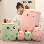 young woman cuddling cute kawaii chonky big and small pink strawberry and green apple fruit bubble tea boba plushies