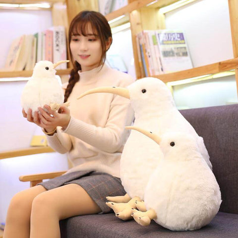 young woman playing with big white fluffy soft chonky cute kawaii kiwi bird plushies