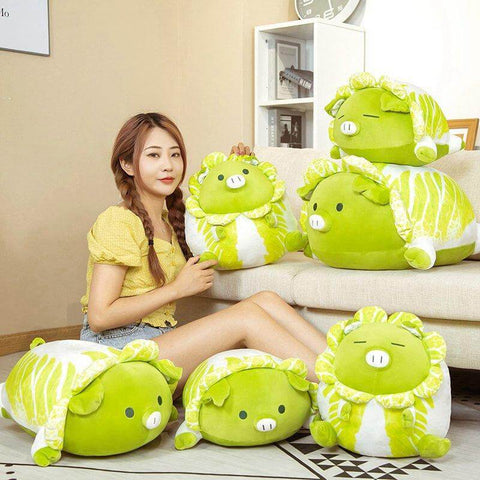 woman playing with cute kawaii chonky green vegetable cabbage pig plushies