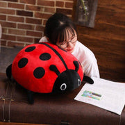 young woman sleeping on cute kawaii chonky soft round mochi ladybug plushie pillow