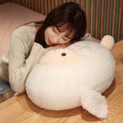 young woman sleeping on fluffy cute kawaii round chonky sheep plushie