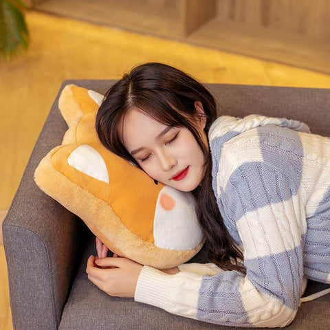 young woman sleeping on cute kawaii chonky fluffy orange shiba inu dog head pillow