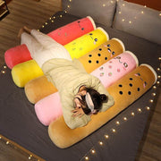 young woman lying on brown, red, yellow, and pink cute kawaii chonky bubble tea boba body pillow dakimakura