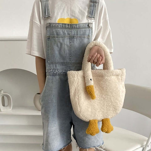 young woman wearing cute kawaii chonky soft fluffy goose neck tote bag handbag on arm