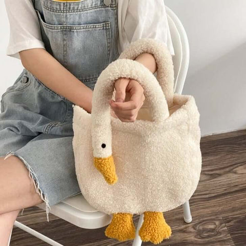 young woman holding cute kawaii chonky soft fluffy goose neck tote bag handbag