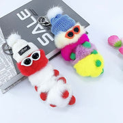 cute kawaii chonky white and rainbow cool caterpillar keyrings with sunglasses, beanie, and sweater on a bag