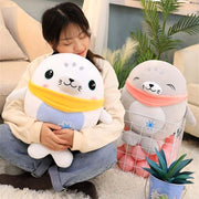 young woman cuddling cute kawaii chonky soft squishy gray and white seal plushies with bandanas
