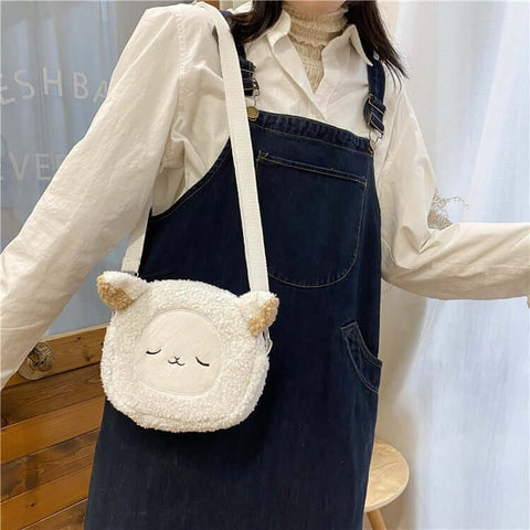 young woman wearing cute kawaii chonky fluffy animal head handbag and bag with shoulder straps in white sheep design