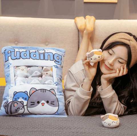 young woman cuddling with cute kawaii chonky bag of mini squishy pudding brown and gray cat plushie balls