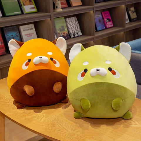 Cute chonky orange and green racoon plushies in a living room